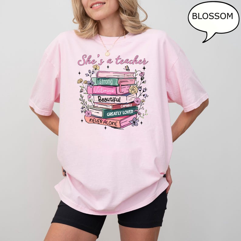 Comfort Colors® She's A Teacher T-Shirt, Book Teacher Shirt, Teacher Gift, Graduation Gift, Teacher School Shirt, Floral Teacher Shirt