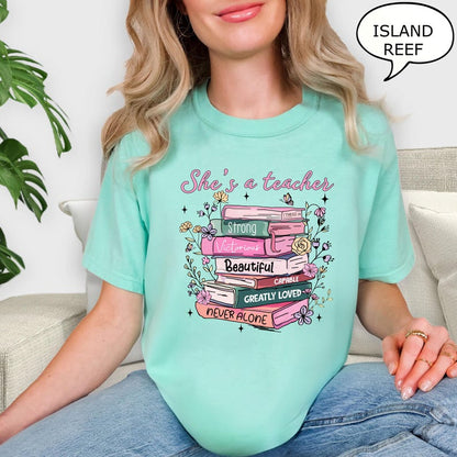 Comfort Colors® She's A Teacher T-Shirt, Book Teacher Shirt, Teacher Gift, Graduation Gift, Teacher School Shirt, Floral Teacher Shirt