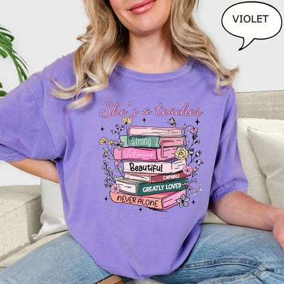 Comfort Colors® She's A Teacher T-Shirt, Book Teacher Shirt, Teacher Gift, Graduation Gift, Teacher School Shirt, Floral Teacher Shirt