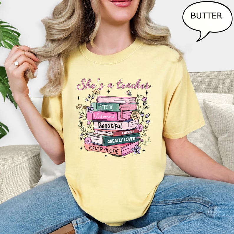 Comfort Colors® She's A Teacher T-Shirt, Book Teacher Shirt, Teacher Gift, Graduation Gift, Teacher School Shirt, Floral Teacher Shirt