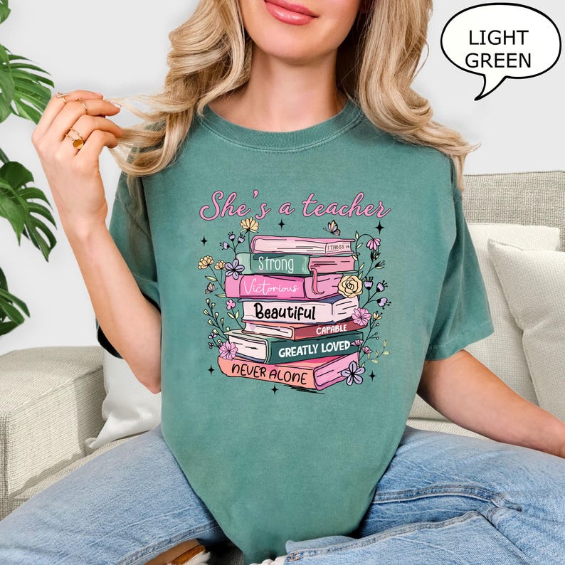 Comfort Colors® She's A Teacher T-Shirt, Book Teacher Shirt, Teacher Gift, Graduation Gift, Teacher School Shirt, Floral Teacher Shirt