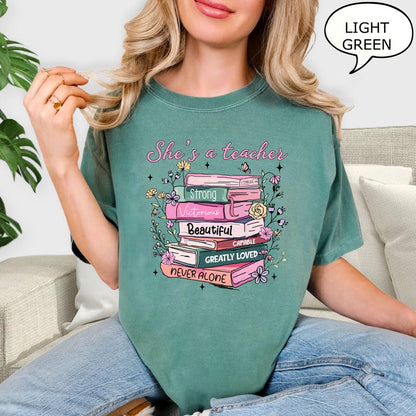 Comfort Colors® She's A Teacher T-Shirt, Book Teacher Shirt, Teacher Gift, Graduation Gift, Teacher School Shirt, Floral Teacher Shirt