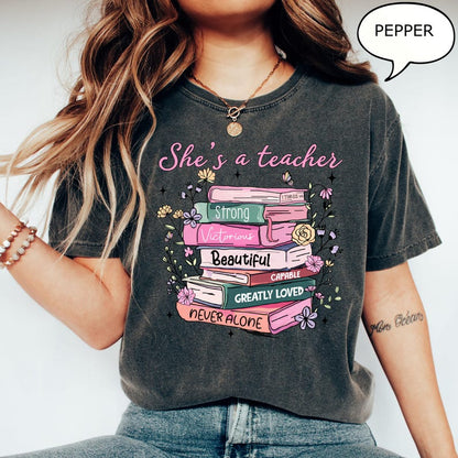 Comfort Colors® She's A Teacher T-Shirt, Book Teacher Shirt, Teacher Gift, Graduation Gift, Teacher School Shirt, Floral Teacher Shirt
